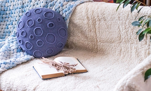 A close-up of a small meditation space in a home, featuring a comfortable cushion, a lit candle, and a small indoor water fountain. Soft, diffused light filters in from a nearby window, creating a peaceful and inviting atmosphere.