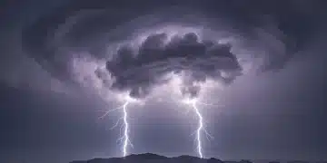 Thunderstorm clouds gathering over a town, symbolizing the 2026 severe weather outlook and potential storm activity.